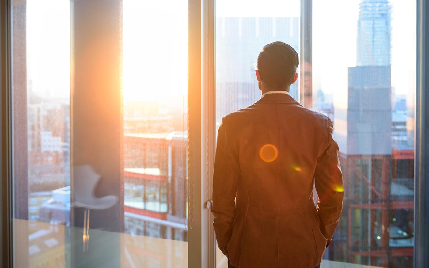 business man looking out window